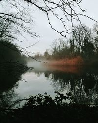 Scenic view of lake against sky at sunset