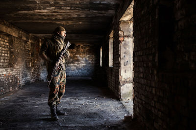 Portrait of serious middle eastern man with ak-47