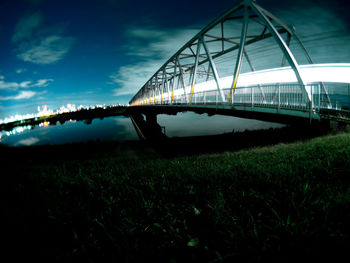 Low angle view of bridge over river against sky