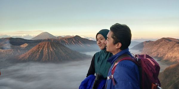 Friends on mountain against sky