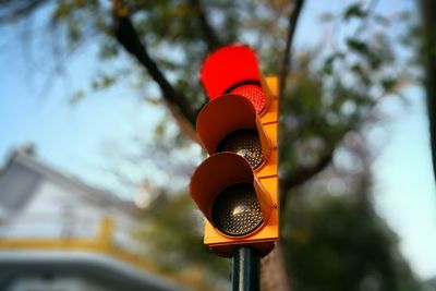 Low angle view of road signal against sky