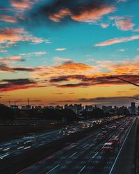 Traffic on road at sunset