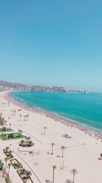 Scenic view of beach against clear blue sky