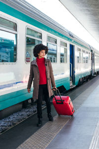 Man standing on train at railroad station platform