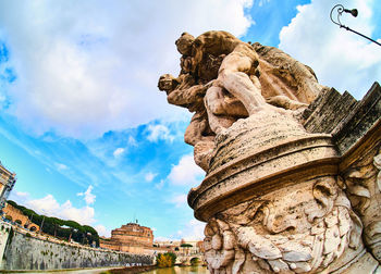 Low angle view of statue against cloudy sky