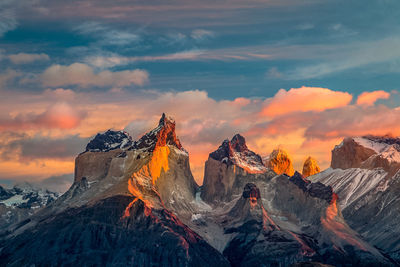 Scenic view of snowcapped mountains against sky during sunset