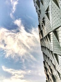 Low angle view of buildings against cloudy sky