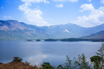 Scenic view of lake and mountains against sky