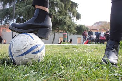 Low section of man playing soccer on field