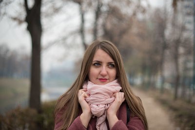 Portrait of beautiful woman against trees