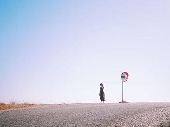 Man standing on field against clear sky