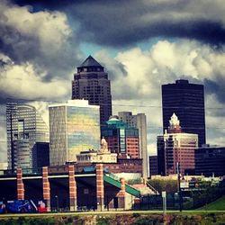 Skyscrapers against cloudy sky
