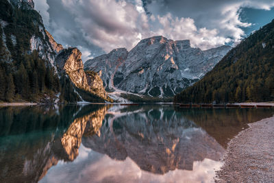 Scenic view of lake by mountains against sky