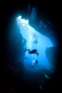 Silhouette of person swimming in sea