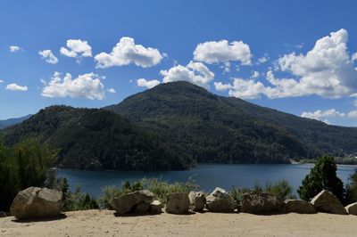 Scenic view of sea and mountains against sky