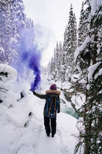 Rear view of woman on snow covered landscape