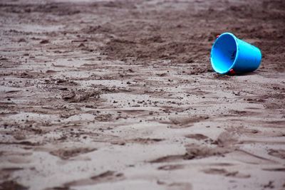 Blue bucket at sandy beach