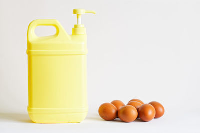 Close-up of orange eggs against white background
