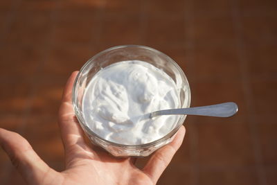 Close-up of hand holding ice cream