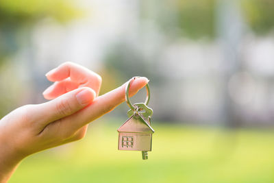 Cropped hand of woman holding key ring