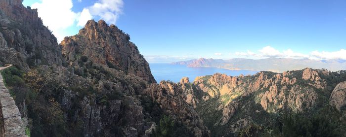 Panoramic view of rocky mountains against sky