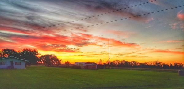 Scenic view of field against sky during sunset