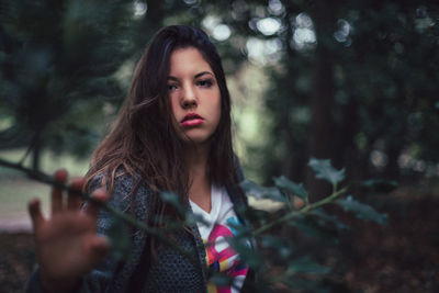 Portrait of serious young woman with long hair