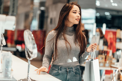 Young woman standing at store