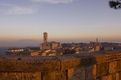 Buildings in city at sunset