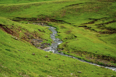 High angle view of stream amidst land