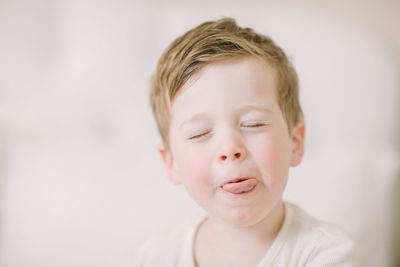 Silly preschooler sticking out tongue up close