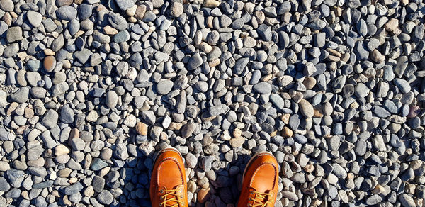 Low section of man standing on stones