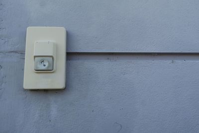 Close-up of telephone booth on wall