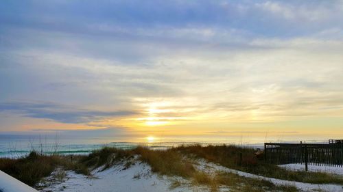 Scenic view of frozen sea against sky during sunset