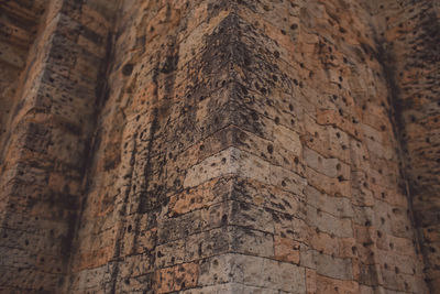 Low angle view of old stone wall