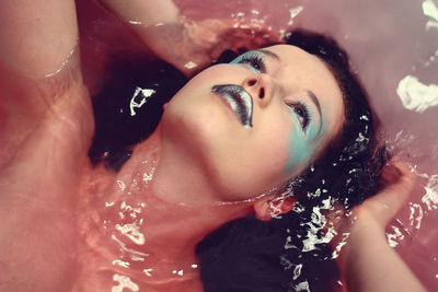 Close-up of young woman in water