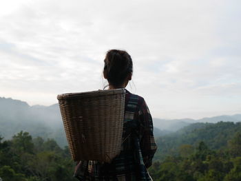 Rear view of woman standing against sky