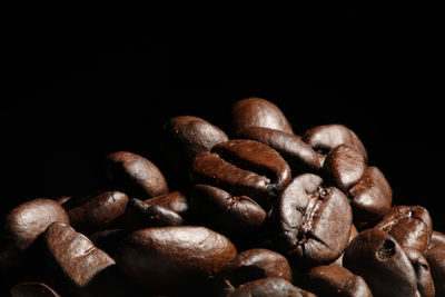 Close-up of coffee beans against black background