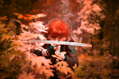 Rear view of woman holding flower