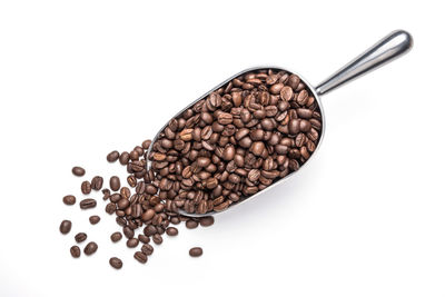 High angle view of coffee beans against white background