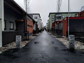 Street amidst buildings in city during winter