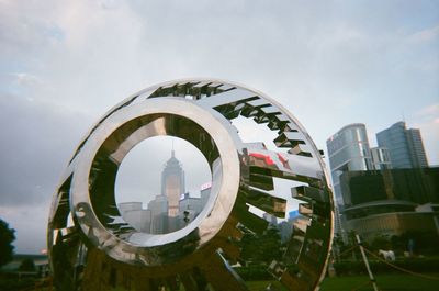 Digital composite image of modern buildings against sky