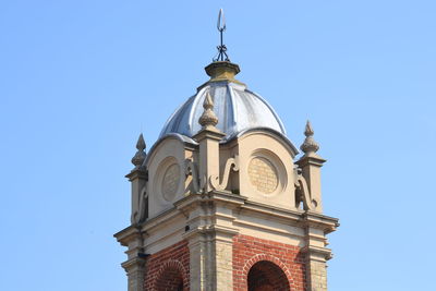 Low angle view of building against clear blue sky