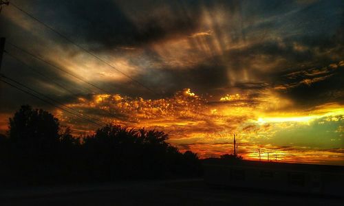 Silhouette landscape against scenic sky