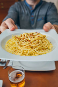 Midsection of man having food in restaurant