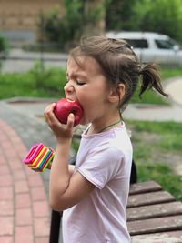 Side view of a girl holding ice cream