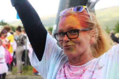 Portrait of mature woman playing holi