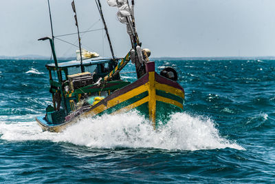 Vietnamese wooden sailing boat in rough seas