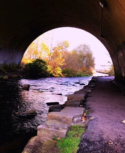 Arch bridge over river in tunnel