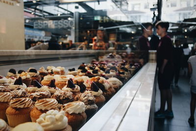 Midsection of woman having food at store